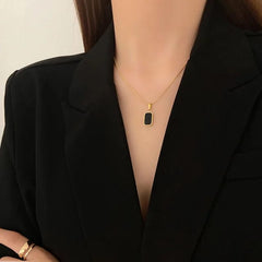 Gold Pendant Necklace with Black Enamel Charm